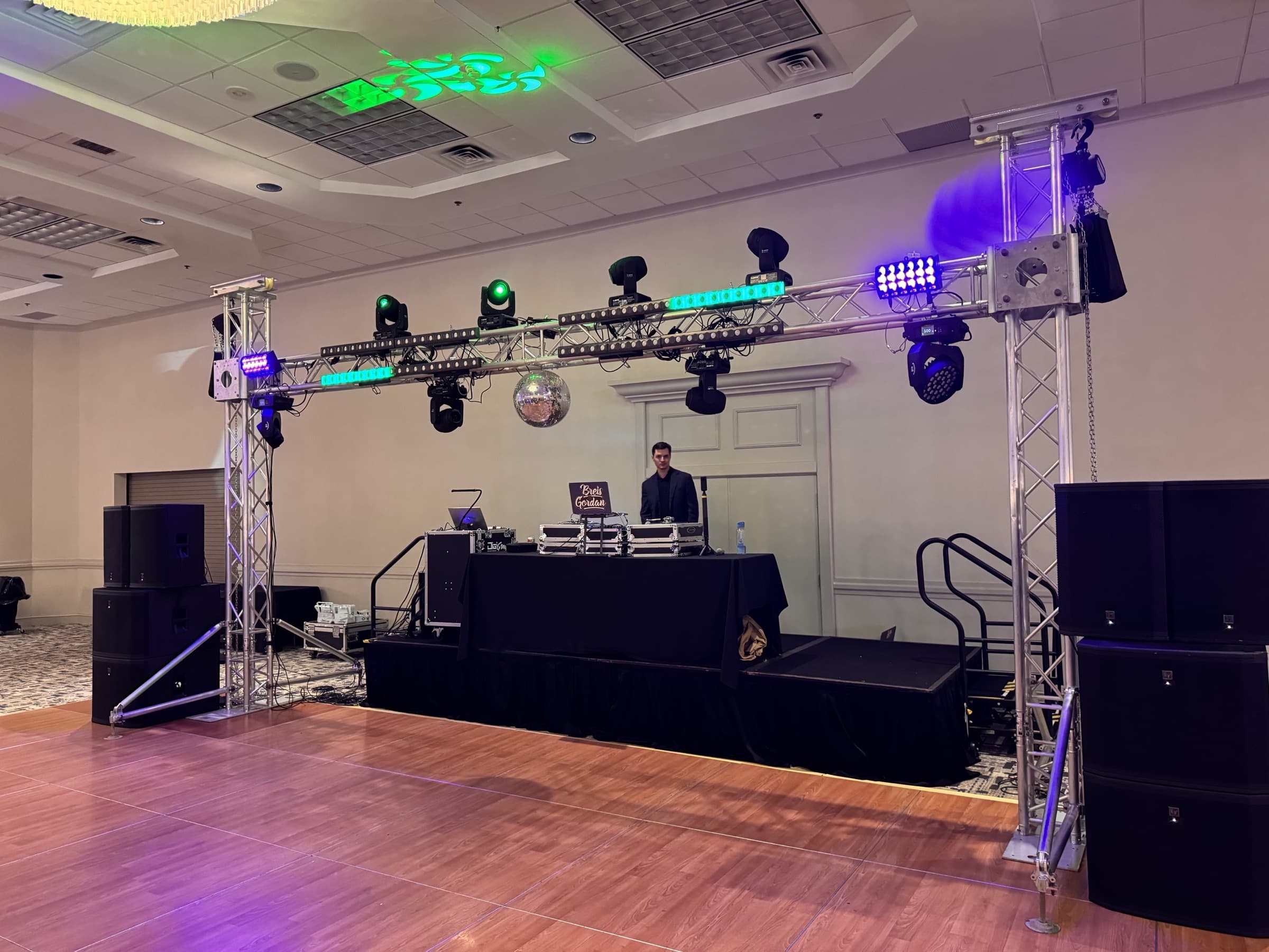 Platinum setup: full goalpost truss with moving heads, LED bars and a real mirror ball above the staged DJ booth