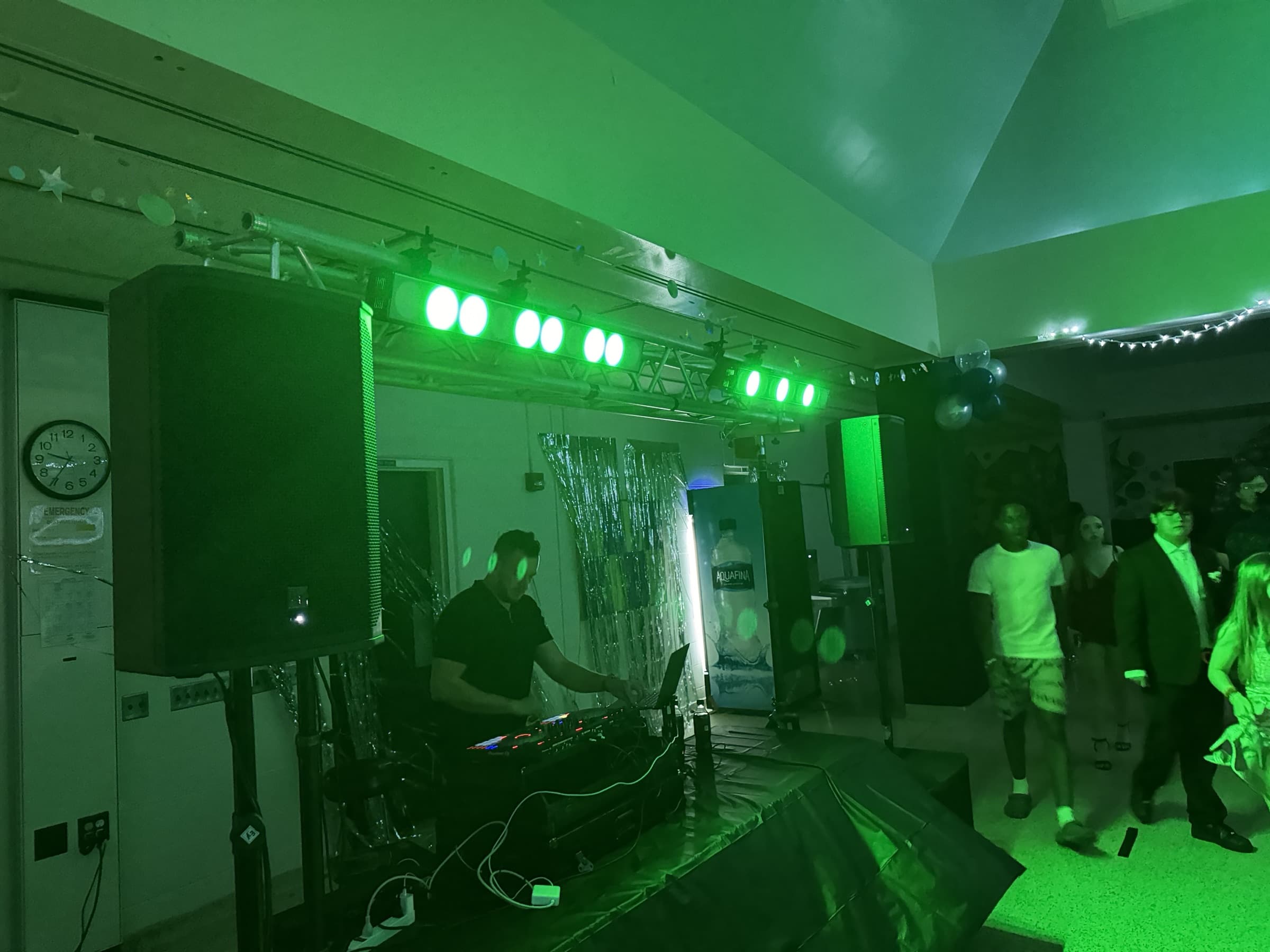 Silver setup washing a school dance floor green as students arrive