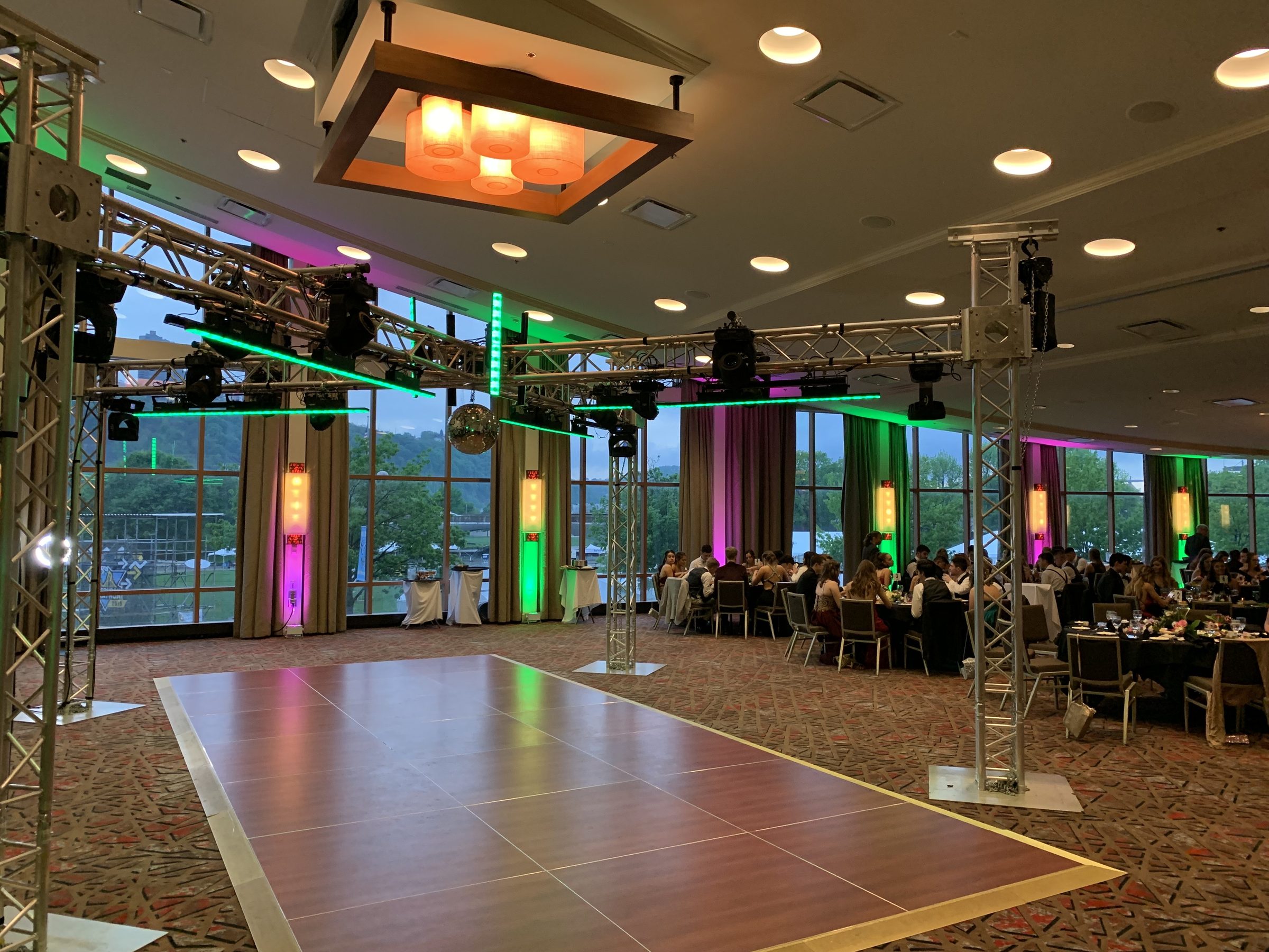 Titanium X package: X-shaped overhead truss on four towers with moving heads, LED bars and a mirror ball above the dance floor